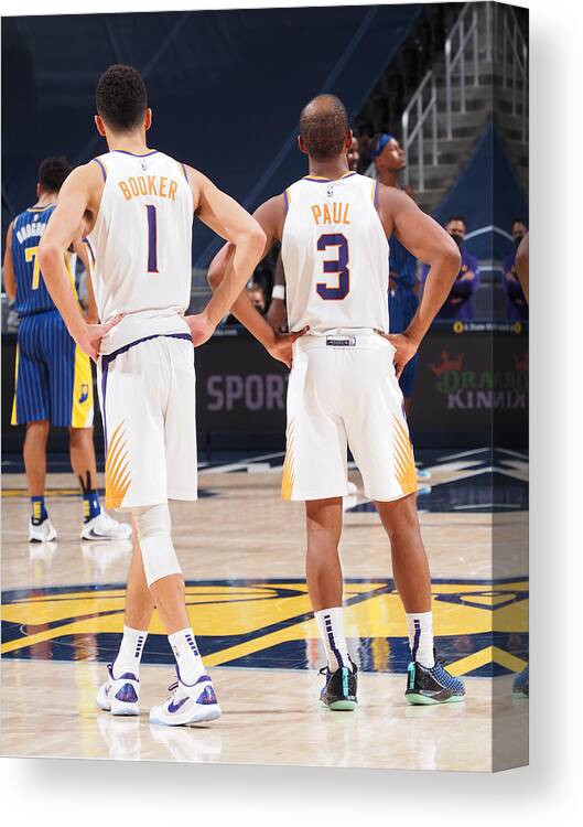 Devin Booker Canvas Print featuring the photograph Devin Booker and Chris Paul by Ron Hoskins