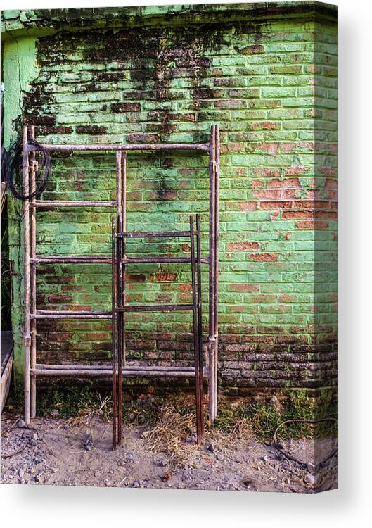 Mexico Canvas Print featuring the photograph Scaffolding against green wall. by Rob Huntley