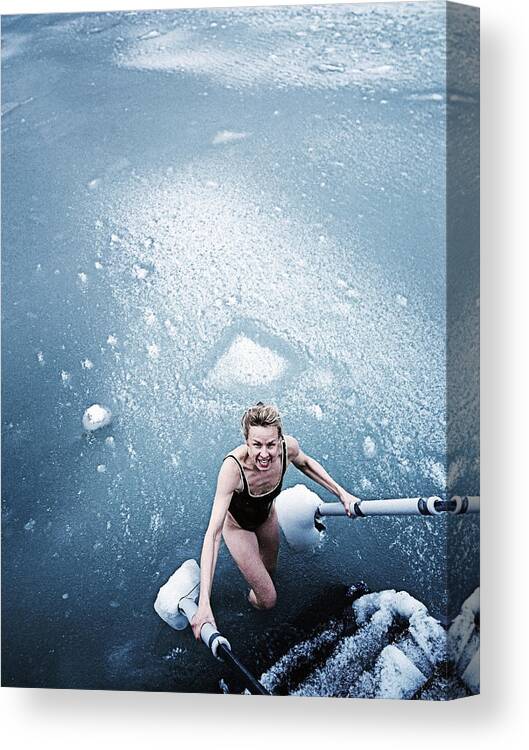 White People Canvas Print featuring the photograph Woman bathing in icy sea. by David Trood
