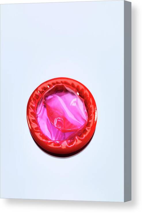 Studio Shot Canvas Print featuring the photograph Red Condom #1 by Tek Image
