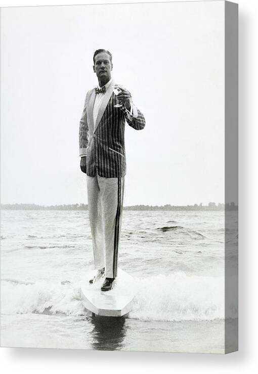 Menswear Canvas Print featuring the photograph A Model Stands In The Surf In Bronzini by Richard Waite