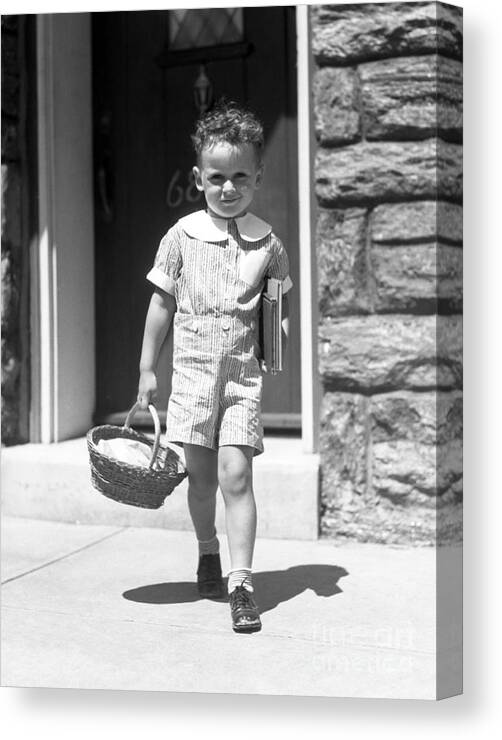 1930s Canvas Print featuring the photograph Boy Walking To School, C.1930s by H. Armstrong Roberts/ClassicStock