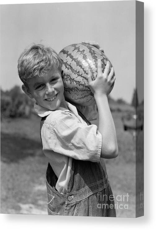 1930s Canvas Print featuring the photograph Farm Boy Carrying Watermelon, C.1930s by H. Armstrong Roberts/ClassicStock