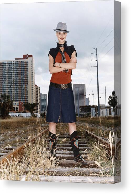 Fedora Canvas Print featuring the photograph Portrait of a Woman in Individual Clothing Standing on an Abandoned Rail Track by Digital Vision.