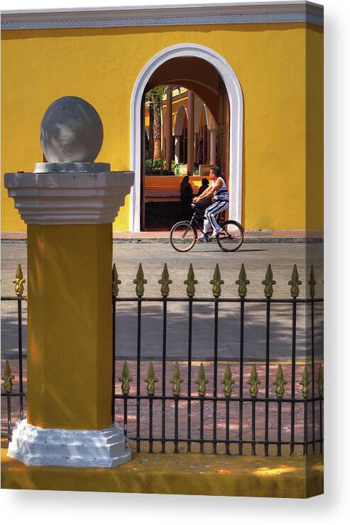 Valladolid Canvas Print featuring the photograph Valladolid Colors - street scene with bicyclist and yellow architecture by Peter Herman