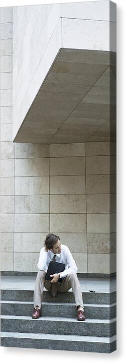 Steps Canvas Print featuring the photograph Businessman sitting on steps, holding file by Matthieu Spohn