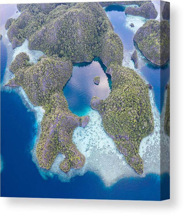 Landscapeaerial Canvas Print featuring the photograph Remote Limestone Islands In Raja Ampat #2 by Ethan Daniels