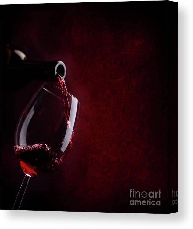 Wine Canvas Print featuring the photograph Red wine pouring in wineglass by Jelena Jovanovic
