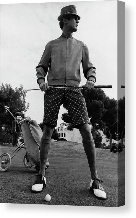 Menswear Canvas Print featuring the photograph A Male Model Posing As A Golfer Wearing by Leonard Nones