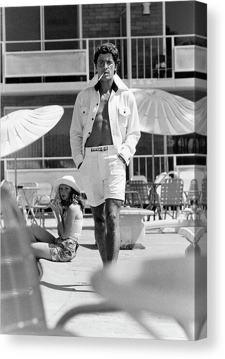 Fashion Canvas Print featuring the photograph A Man And Woman By A Pool by Stephen Ladner