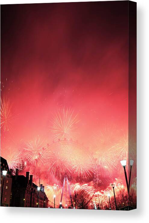 Atmosphere Canvas Print featuring the photograph New Years Eve Fireworks Display In by Gary Yeowell