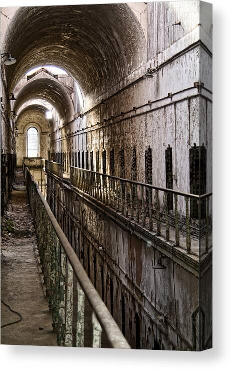 Eastern State Penitentiary Canvas Print featuring the photograph Ominous Corridor by Michael Dorn