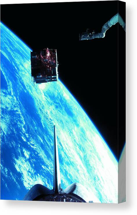 Vertical Canvas Print featuring the photograph A Satellite Orbiting Above The Earth #5 by Stockbyte
