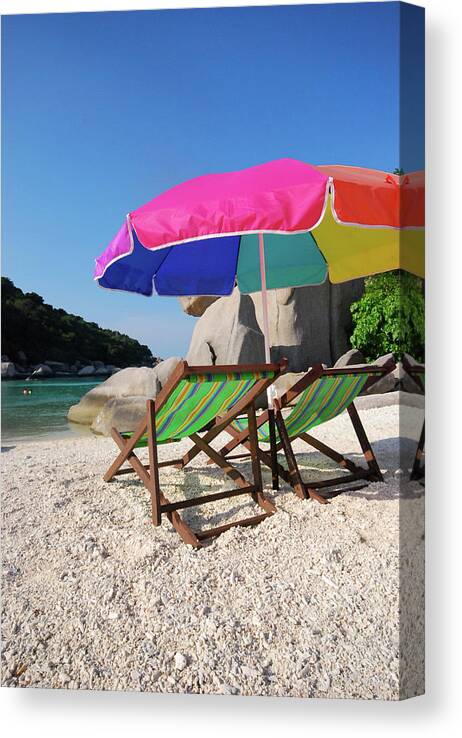Clear Sky Canvas Print featuring the photograph Deck Chairs On A Beach In Thailand by Thepurpledoor