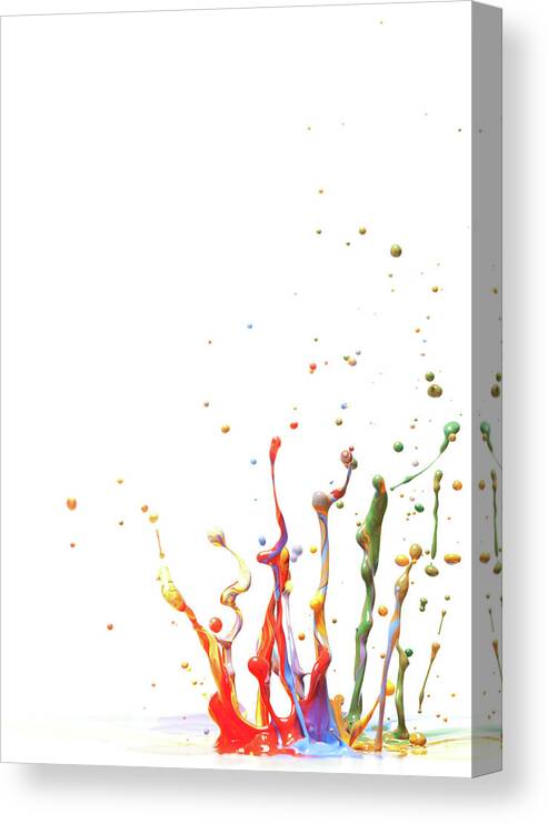 Orange Color Canvas Print featuring the photograph Multicolor Paint Splash Against A White by Banksphotos