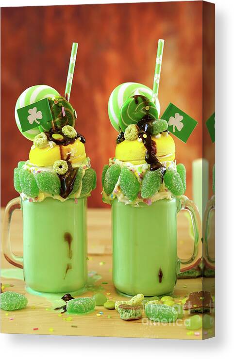 St Patricks Day Canvas Print featuring the photograph St Patrick's Day on-trend holiday freak shakes with candy and lollipops. by Milleflore Images