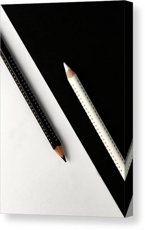 Pencil Canvas Print featuring the photograph Two drawing pencils on a black and white surface. by Michalakis Ppalis