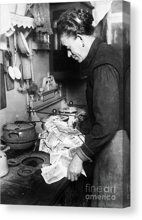 People Canvas Print featuring the photograph Woman Using Paper Money To Light Stove by Bettmann