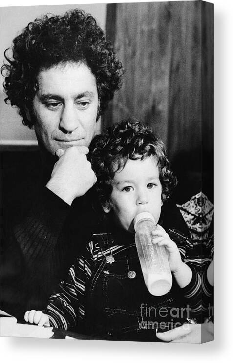 Toddler Canvas Print featuring the photograph Writer Abbie Hoffman Holding His Son by Bettmann