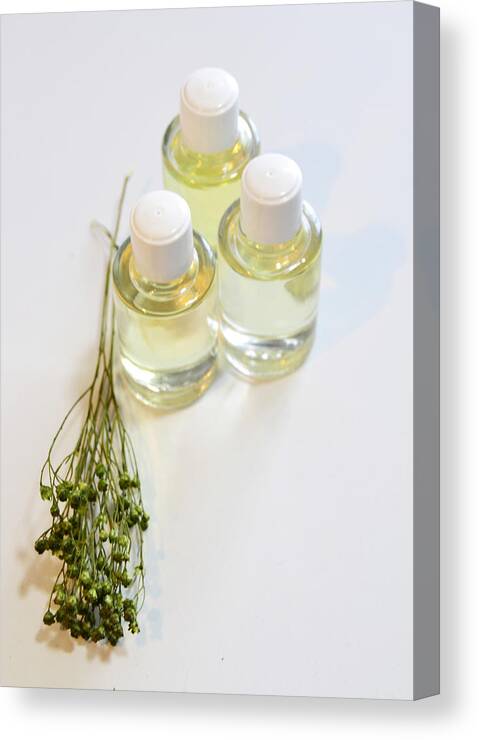 White Background Canvas Print featuring the photograph Aromatic oils on white background by Blanchi Costela