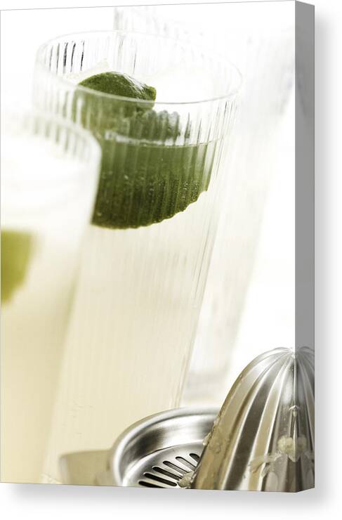 Alcohol Canvas Print featuring the photograph Cocktails with lime, close-up. by Luk Thys
