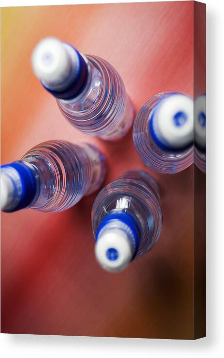 Outdoors Canvas Print featuring the photograph High angle view of four water bottles by Glowimages