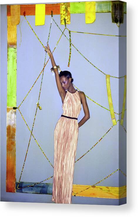 Art Canvas Print featuring the photograph Iman Wearing A Pink Mary McFadden Pleated Dress by Ishimuro