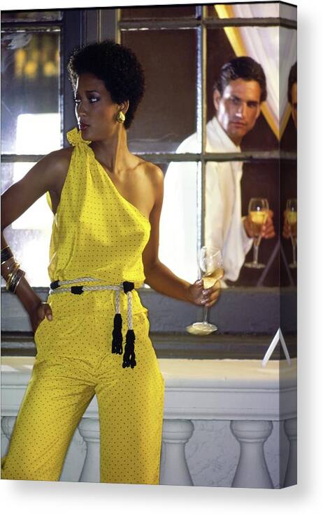 Fashion Canvas Print featuring the photograph Peggy Dillard Wearing A Yellow One Shoulder Jumpsuit by Guy Le Baube