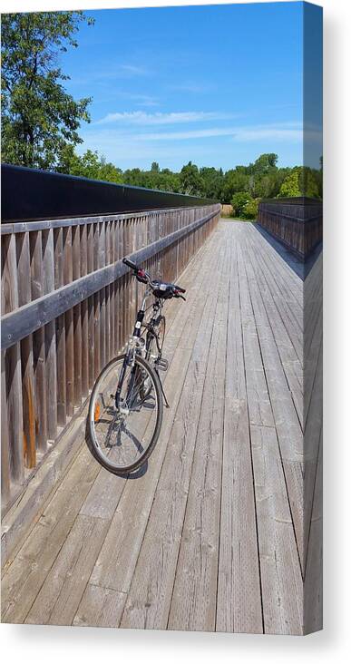 Bicycle Canvas Print featuring the photograph Bicycle on Bridge by Lucie Dumas