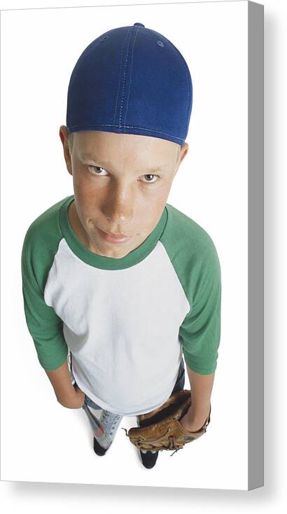 Baseball Cap Canvas Print featuring the photograph A Caucasian Male Preteen In A Green And White Shirt And Blue Cap Holds His Mitt And Smirks Looking Up Towards The Camera by Photodisc