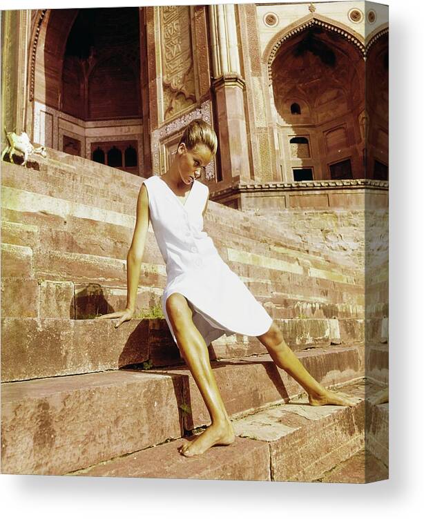 Architecture Canvas Print featuring the photograph Veruschka Wearing A Teal Traina Dress by Henry Clarke