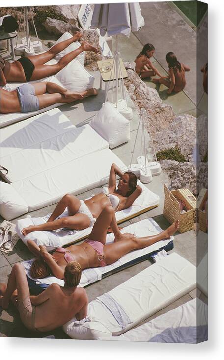 Recreational Pursuit Canvas Print featuring the photograph Sunbathers At Eden Roc by Slim Aarons