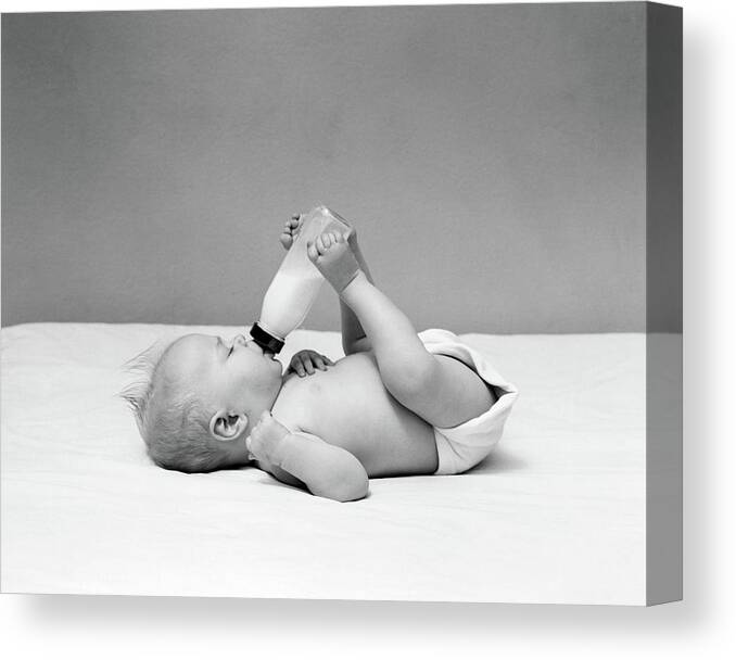 Photography Canvas Print featuring the photograph 1940s Baby Prone Drinking From Milk by Vintage Images