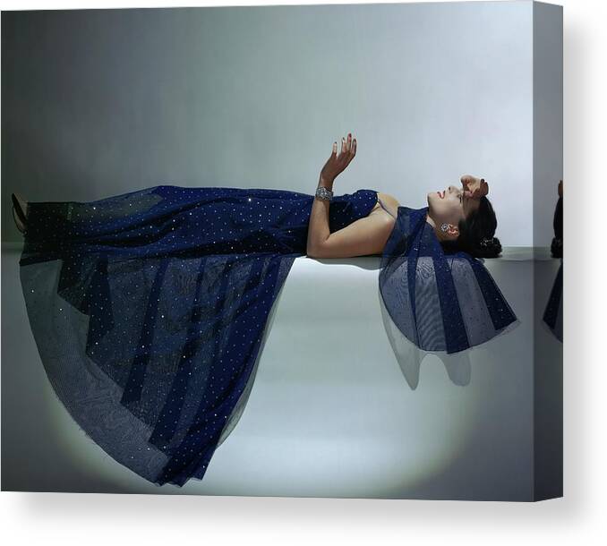 Fashion Canvas Print featuring the photograph A Model Wearing An Evening Gown by John Rawlings
