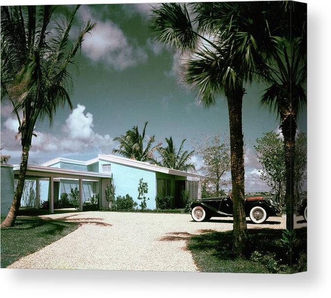 Nobodyoutdoorsdaytimehousedwellingdrivewayretroold-fashionedvintagevintage Cartransportationcarmotor Vehicleautomobilevehicletreemiamimiami-dade Countyfloridausanorth Americasouthern United Statesnorth American Atlantic Coastrobert M. Littlearchitecture #condenasthouse&gardenphotograph November 1st 1955 Canvas Print featuring the photograph A Vintage Car Parked Outside A Blue House by Tom Leonard