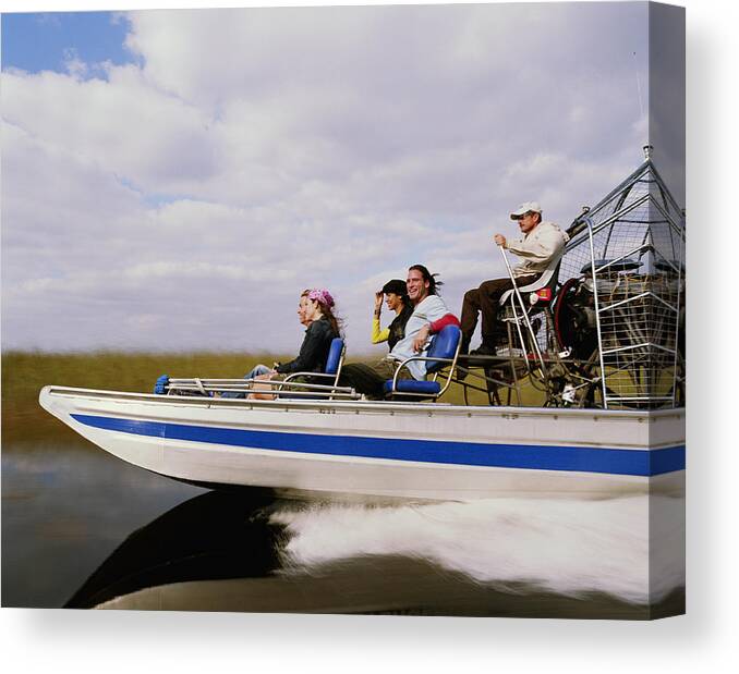Young Men Canvas Print featuring the photograph Driver and four passengers on airboat, side view by Ryan McVay