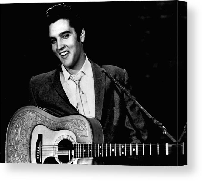 Classic Canvas Print featuring the photograph Elvis Presley Smiles While Holding Guitar by Retro Images Archive