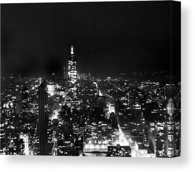 1945 Canvas Print featuring the photograph Midtown Manhattan At Night by Underwood Archives