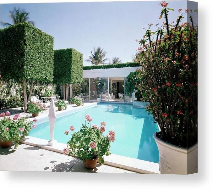 Architecture Canvas Print featuring the photograph The Pool And Garden Of A Home by William Grigsby