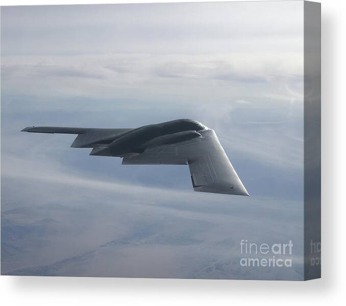 B-2 Spirit Canvas Print featuring the photograph A B-2 Spirit Soars Through The Sky #1 by Stocktrek Images