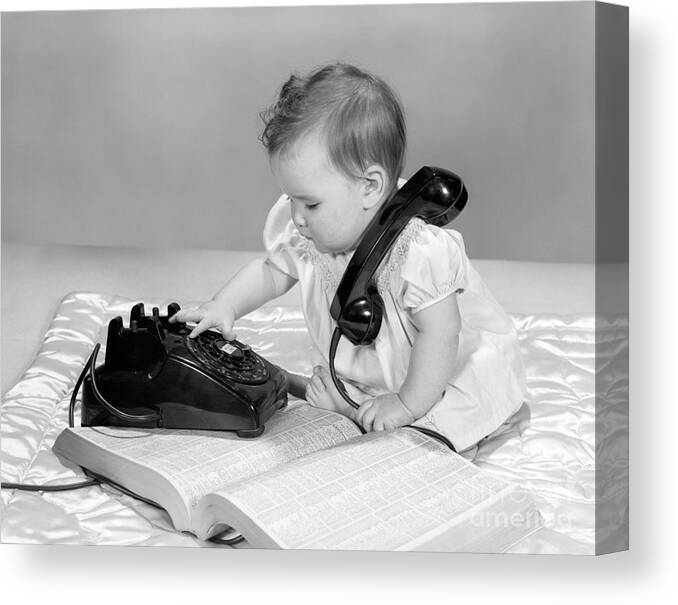 1950s Canvas Print featuring the photograph Baby With Phonebook And Phone, 1960s by H. Armstrong Roberts/ClassicStock
