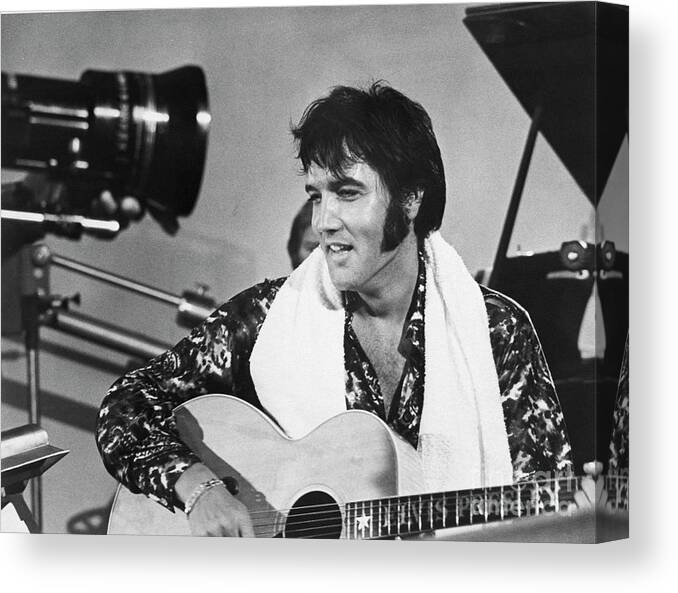 Rock Music Canvas Print featuring the photograph Elvis Presley With Guitar #1 by Bettmann