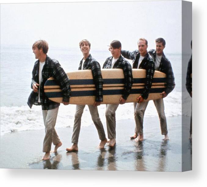 Music Canvas Print featuring the photograph Beach Boys On The Beach With A Surfboard by Michael Ochs Archives