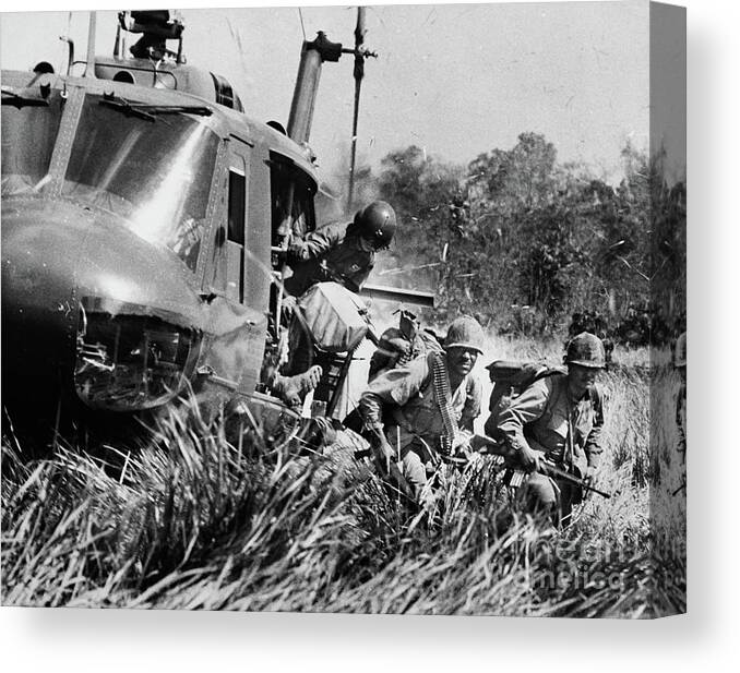 Vietnam War Canvas Print featuring the photograph American Soldiers Exit A Helicopter by Bettmann