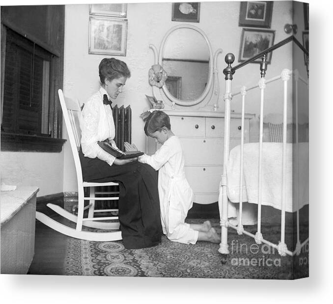 Child Canvas Print featuring the photograph Boy And Mother Praying by Bettmann