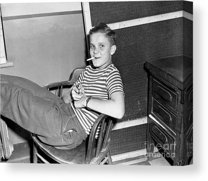 Following Canvas Print featuring the photograph Boy With His Legs Propped Up On Desk by Bettmann