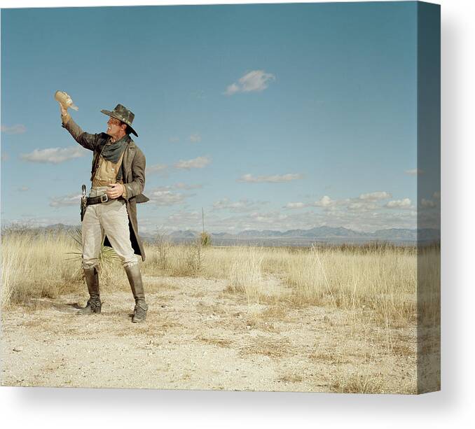 Problems Canvas Print featuring the photograph Cowboy Standing In Desert With Empty by Matthias Clamer