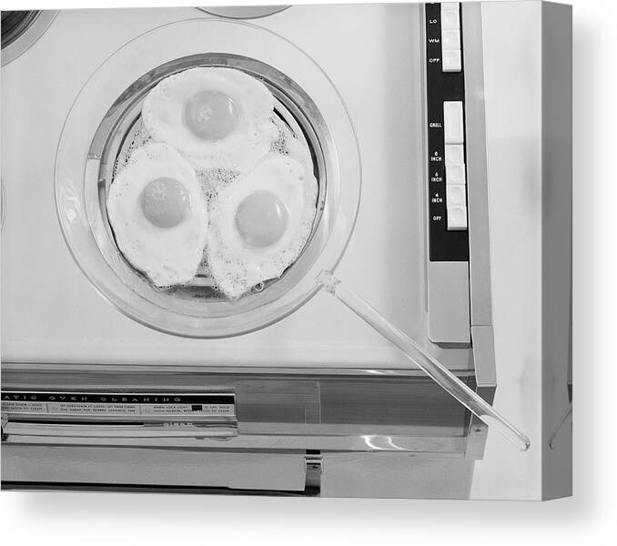 Electric Stove Burner Canvas Print featuring the photograph Egg Frying In Electric Hob, Close-up by Tom Kelley Archive