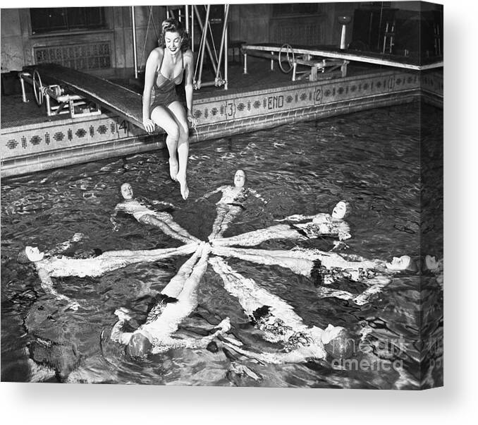 Synchronized Swimming Canvas Print featuring the photograph Esther Williams Sitting Above Swimmers by Bettmann