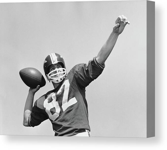 American Football Uniform Canvas Print featuring the photograph Man Throwing Football by Stockbyte